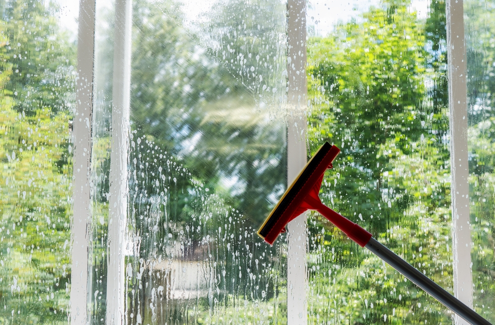 window being cleaned with a squeegee