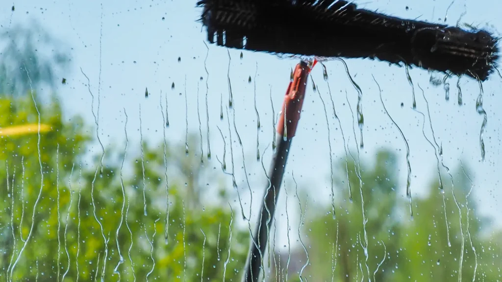 window cleaning tool being used to clean a window